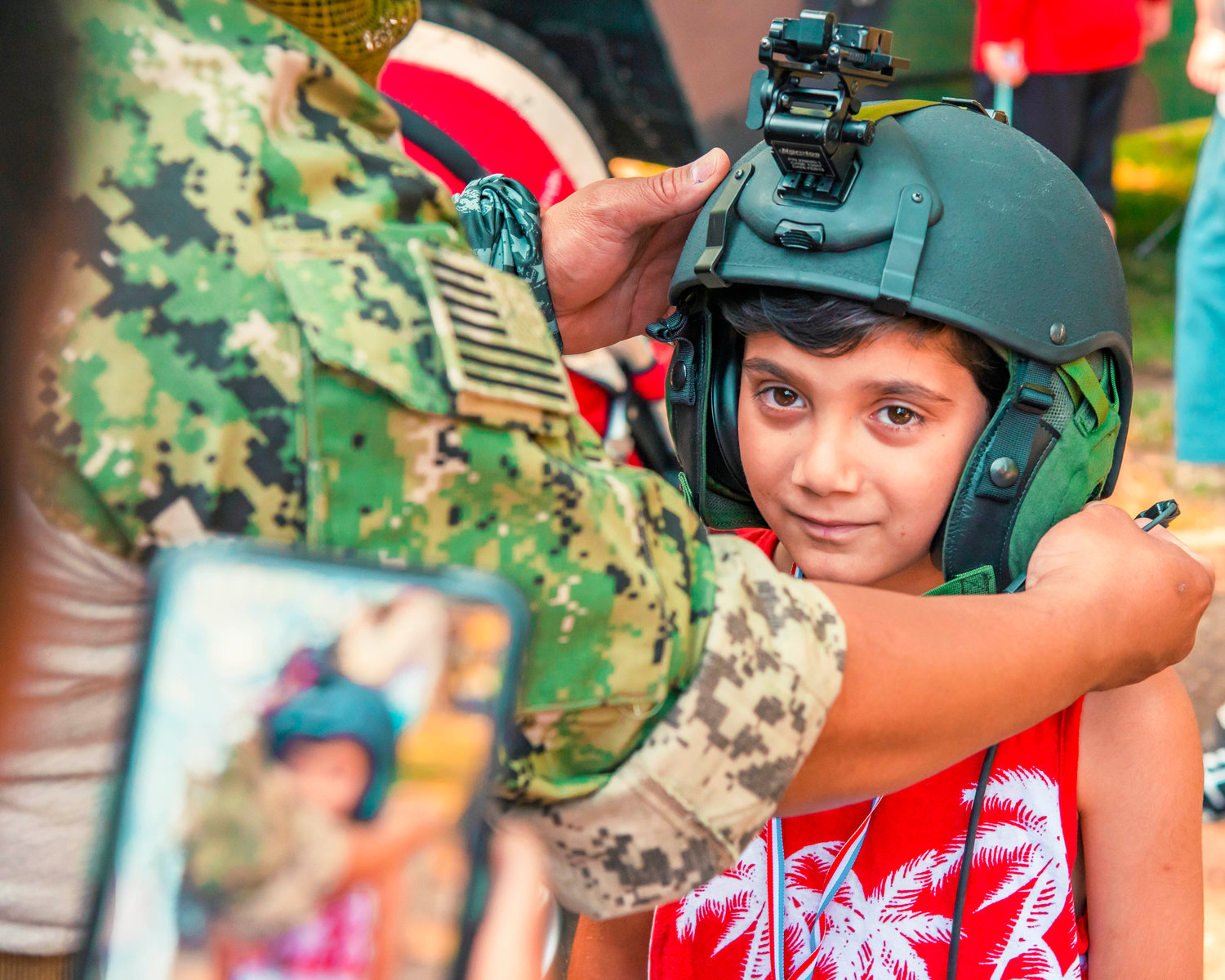 Seth Alldis smiles as he tries on a helmet worn by military during Summerfest at Borst Park for Fourth of July Sunday afternoon in Centralia.